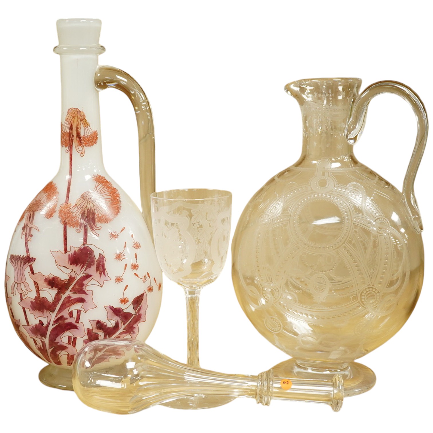 A Continental Art Nouveau glass carafe enamelled with flowers, an English wine glass engraved with the symbols of the Union, a Victorian engraved claret jug and a toddy lifter. Condition - carafe has some occasional scra